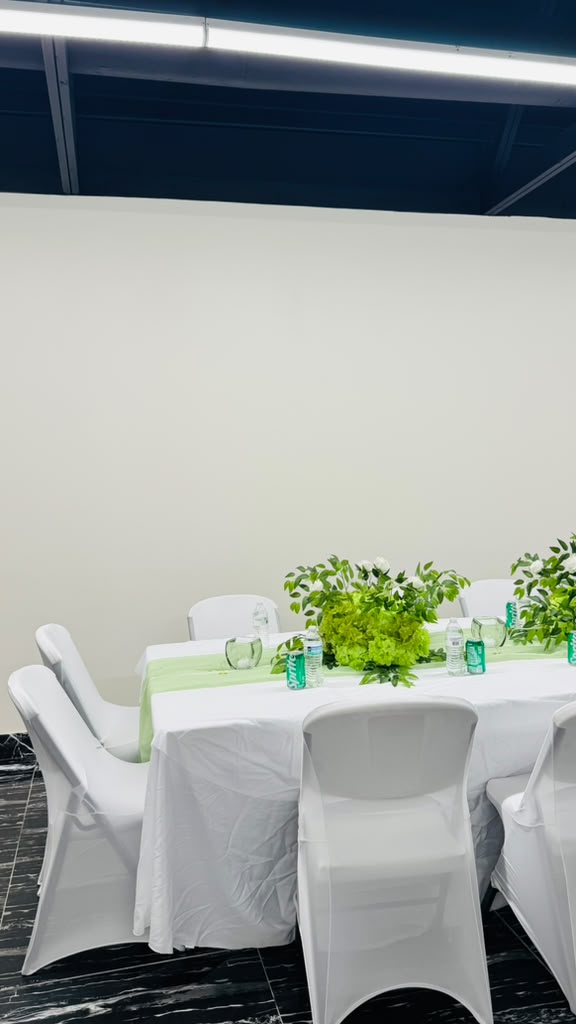 Guest tables dressed in white chair covers