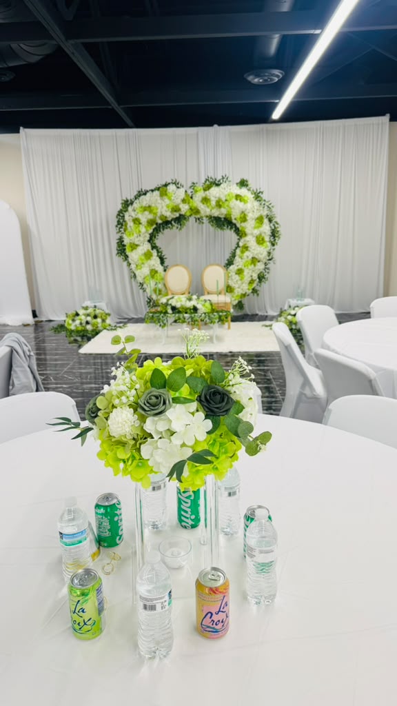 Floral heart arch behind the sweetheart table